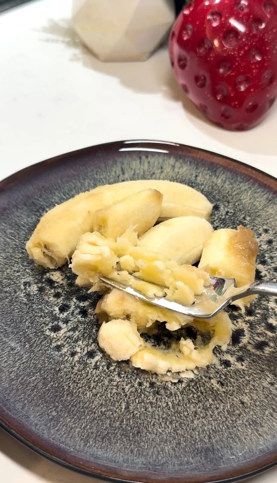ripe bananas being mashed with a fork for healthy chocolate banana pudding