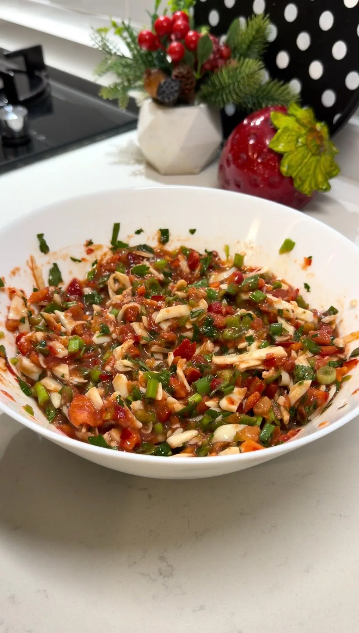 Vegetable and cheese pizza topping being spooned onto sliced bread