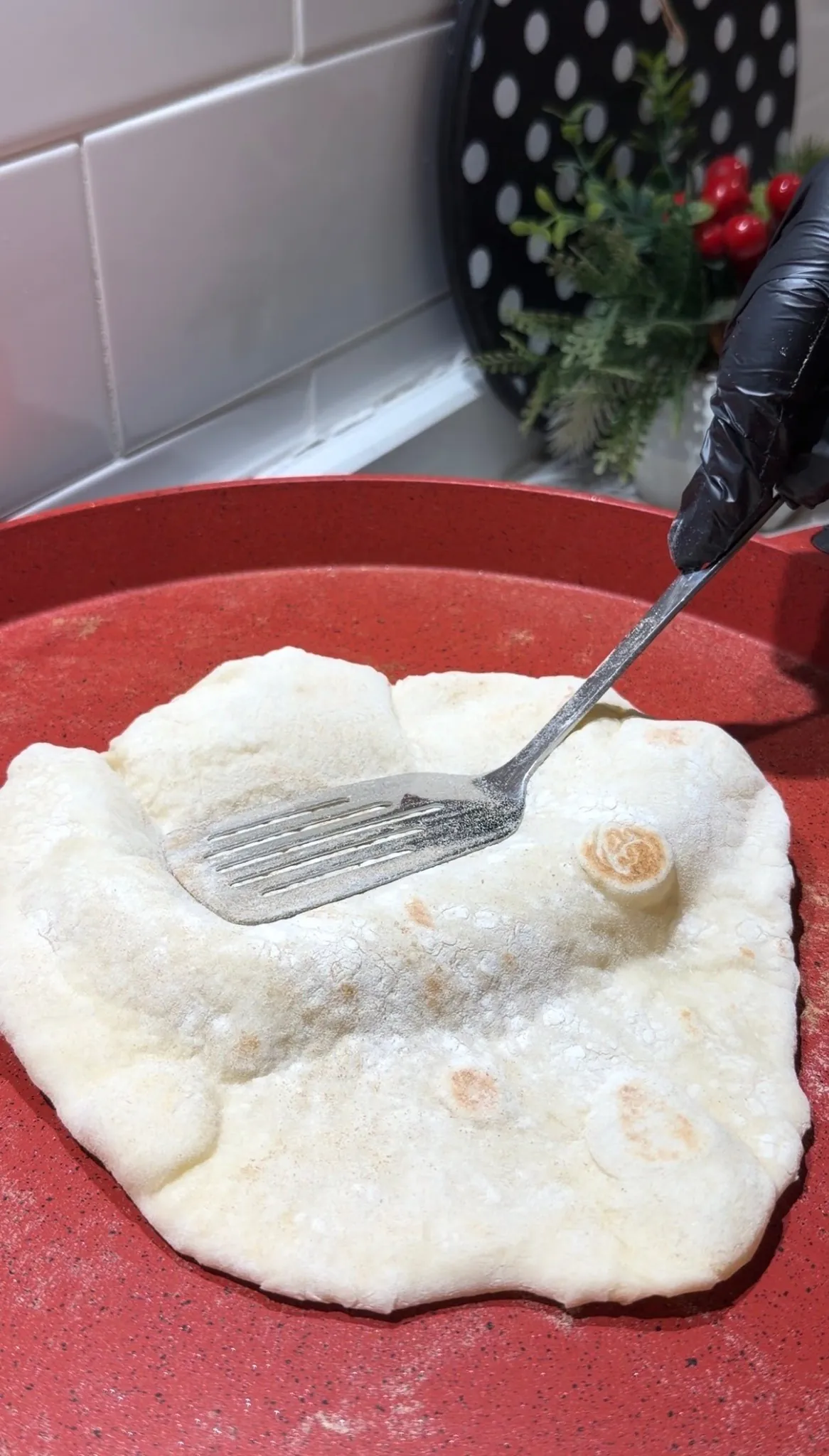 Fully puffed balloon flatbread creating an air pocket while cooking