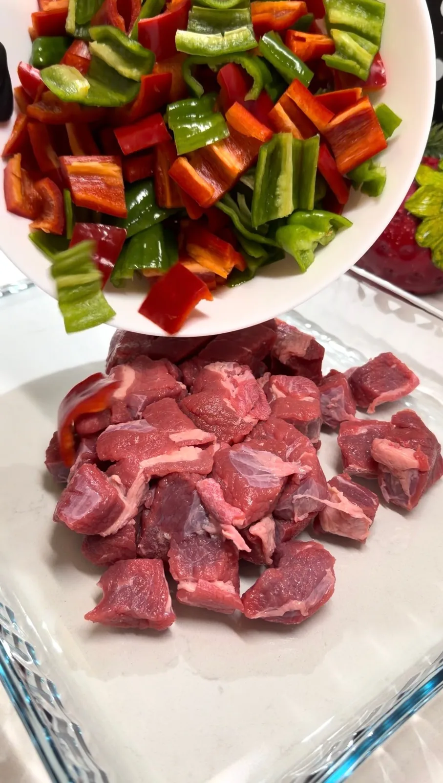 cubed beef and chopped red and green peppers prepared for Belen Tava