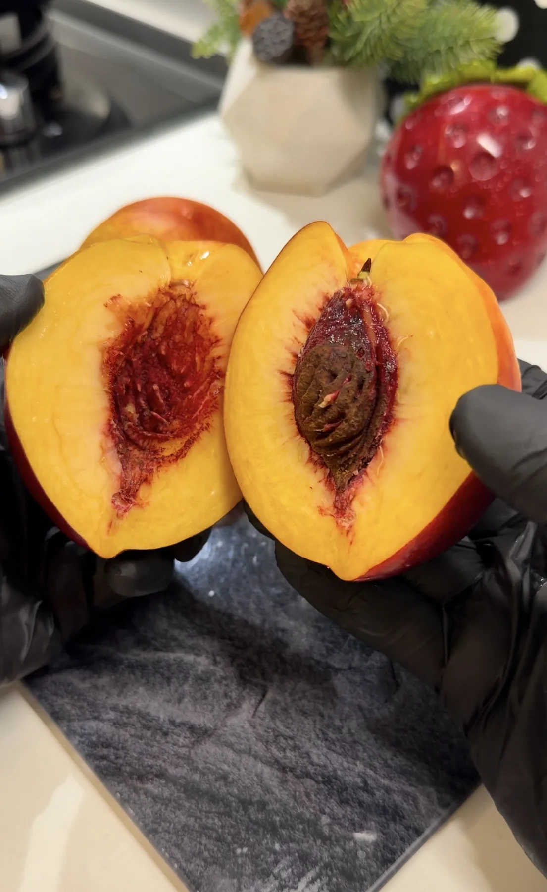 Fresh peach cut in half with the pit being removed