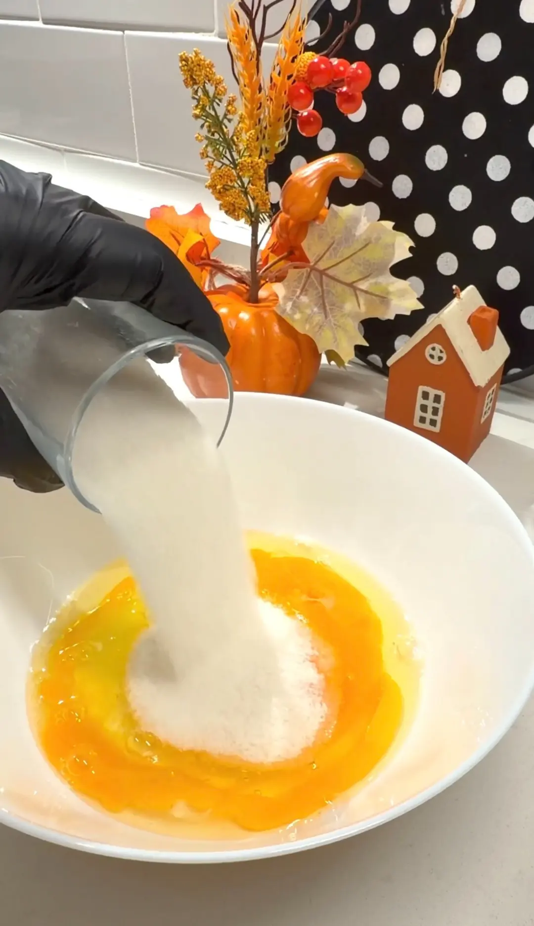 Eggs and sugar being mixed for carrot cinnamon walnut cake