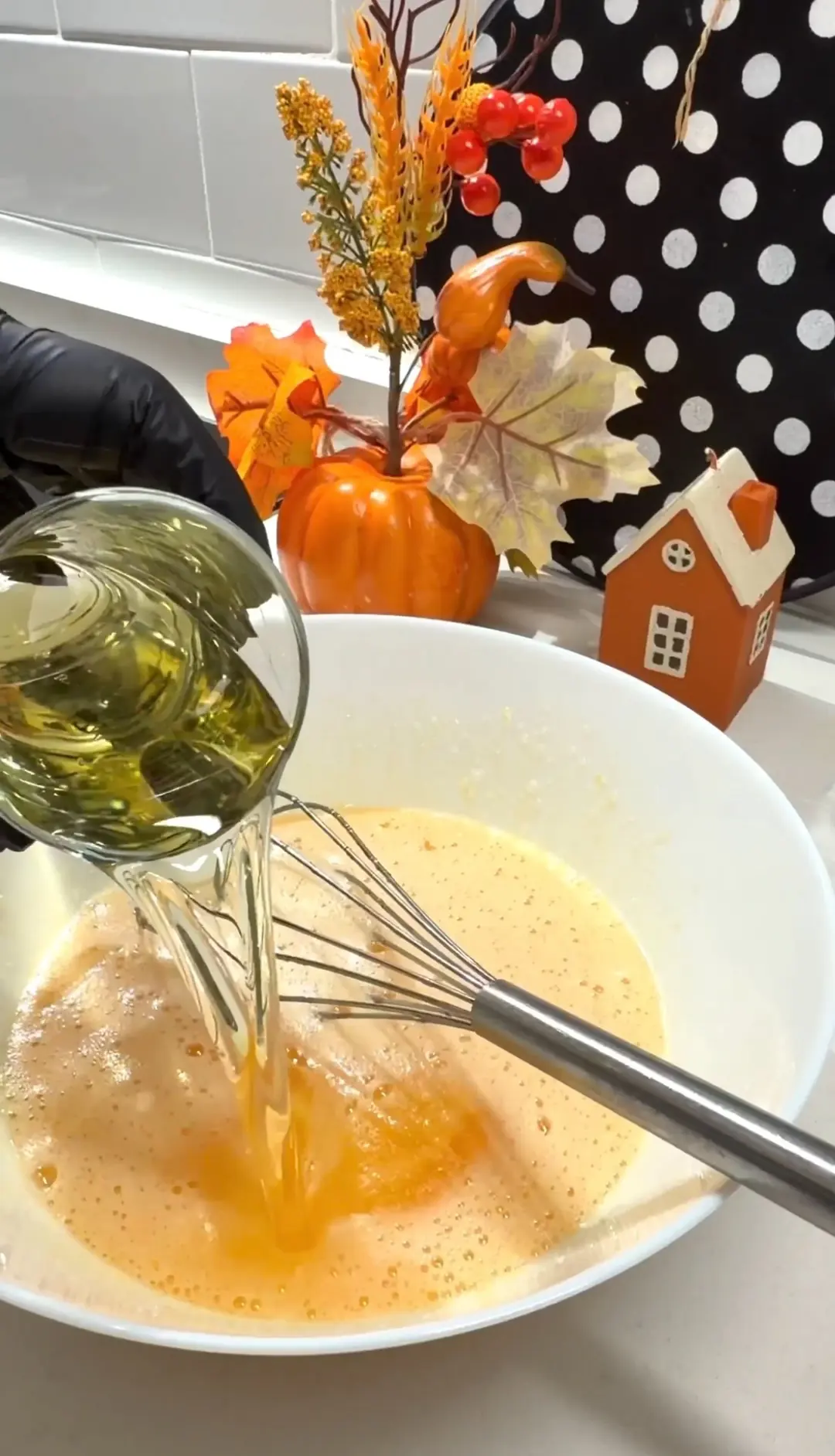 Vegetable oil being added to carrot cake batter