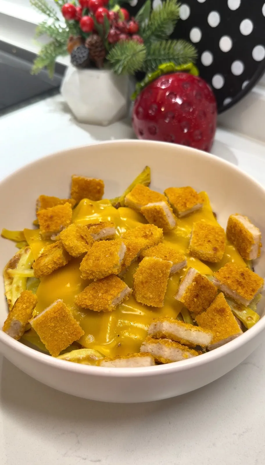 creamy burger sauce with chopped pickles being added to a chicken bowl
