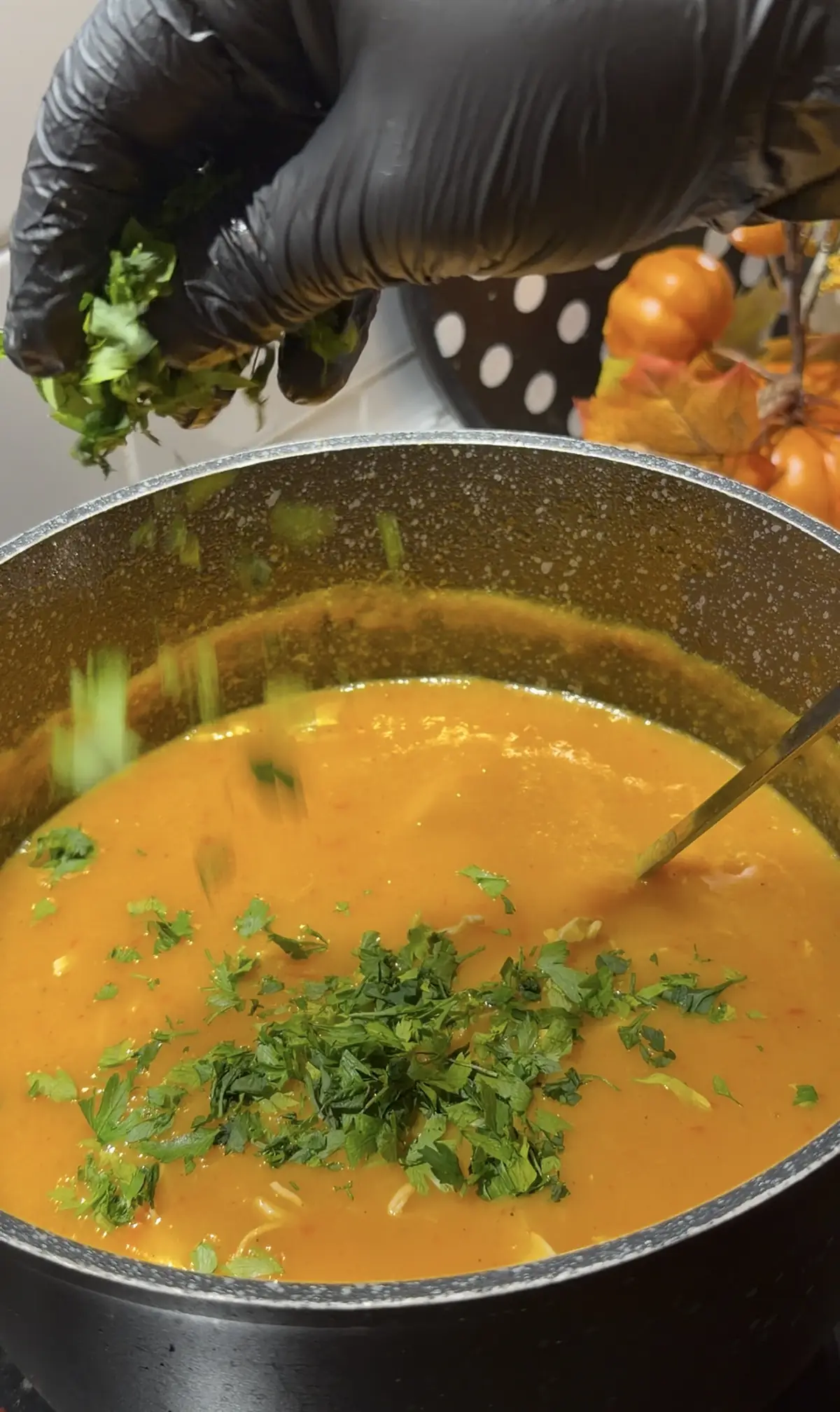 Fresh chopped parsley being added to creamy chicken vegetable soup