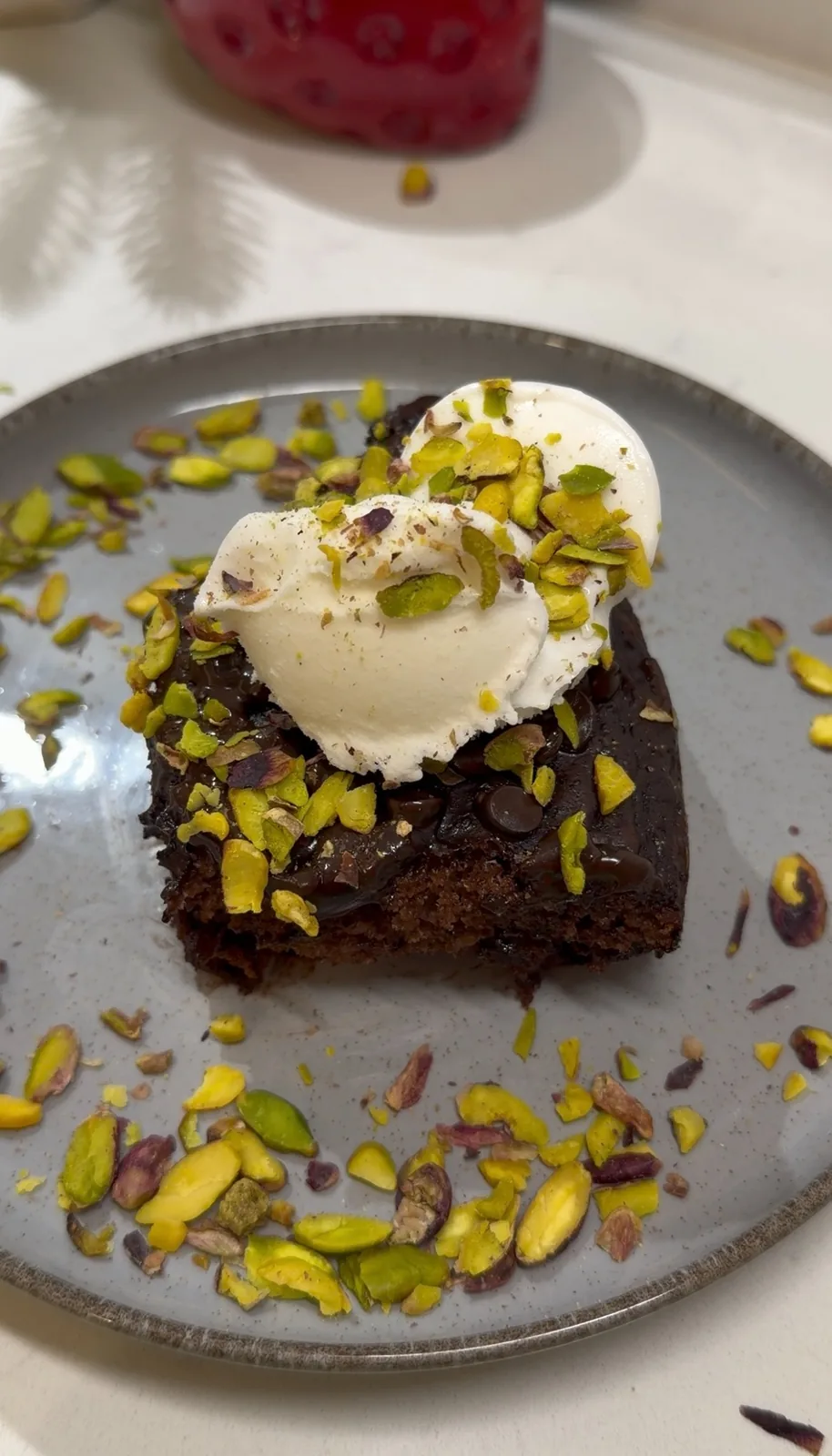 Slice the cake once it has rested slightly. Serve as it is or add a scoop of ice cream and extra pistachios for a more indulgent dessert.