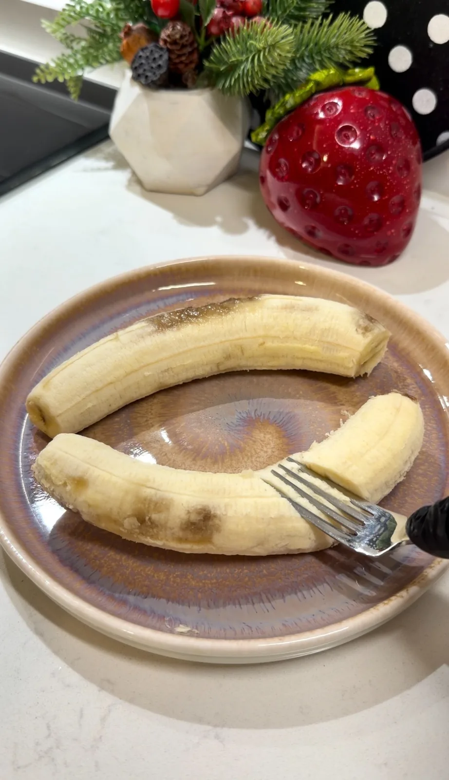 Ripe bananas being mashed with a fork for banana ice cream filling