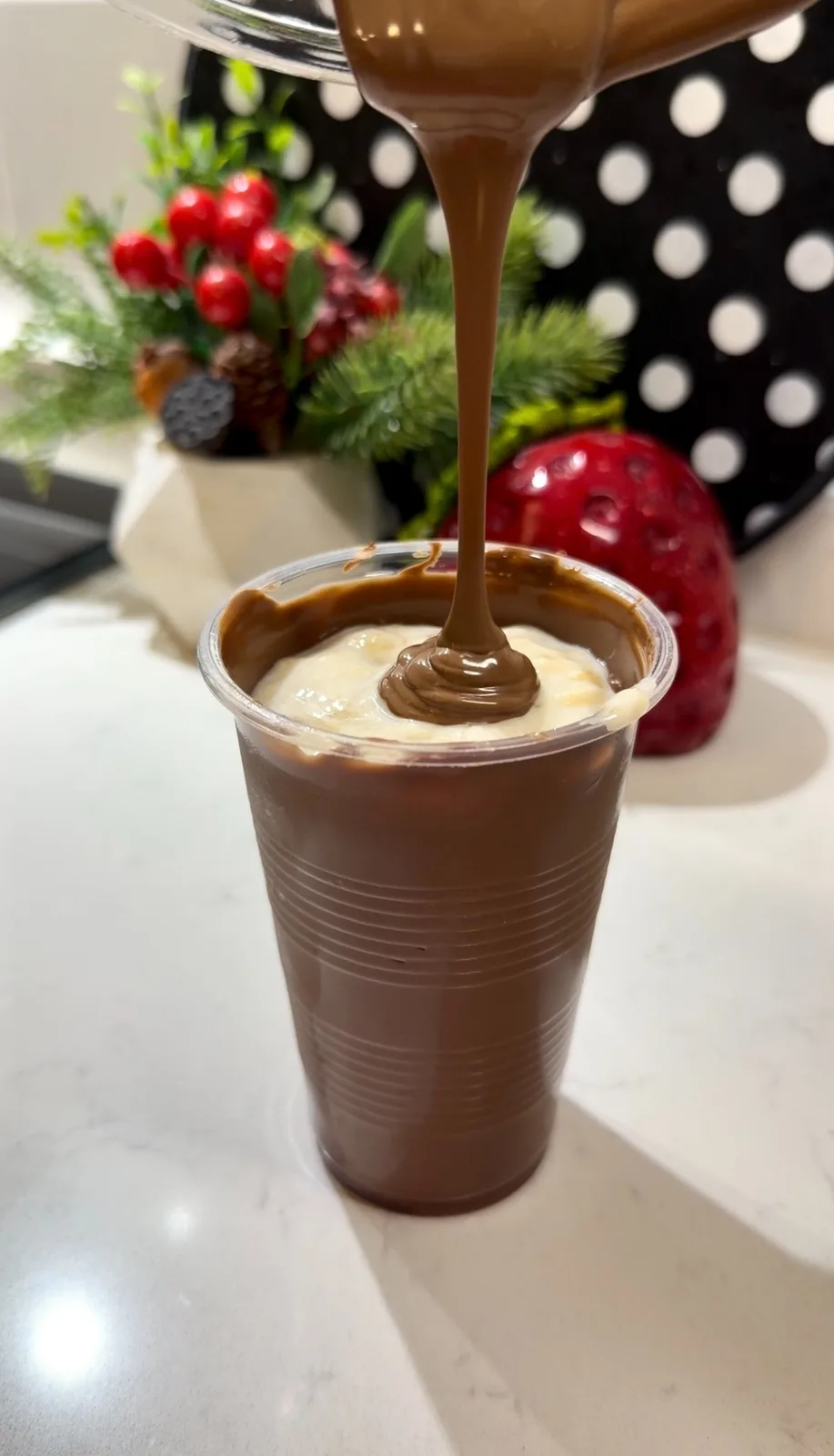 Banana yogurt filling inside a homemade milk chocolate cup shell