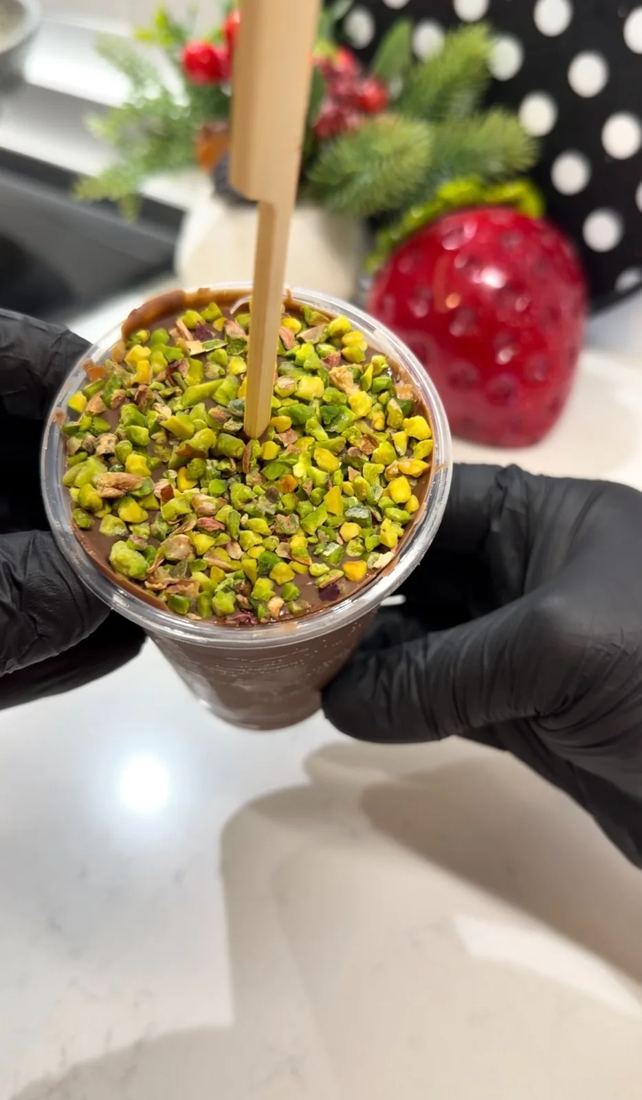 Chocolate banana cup ice cream topped with chopped pistachios before freezing