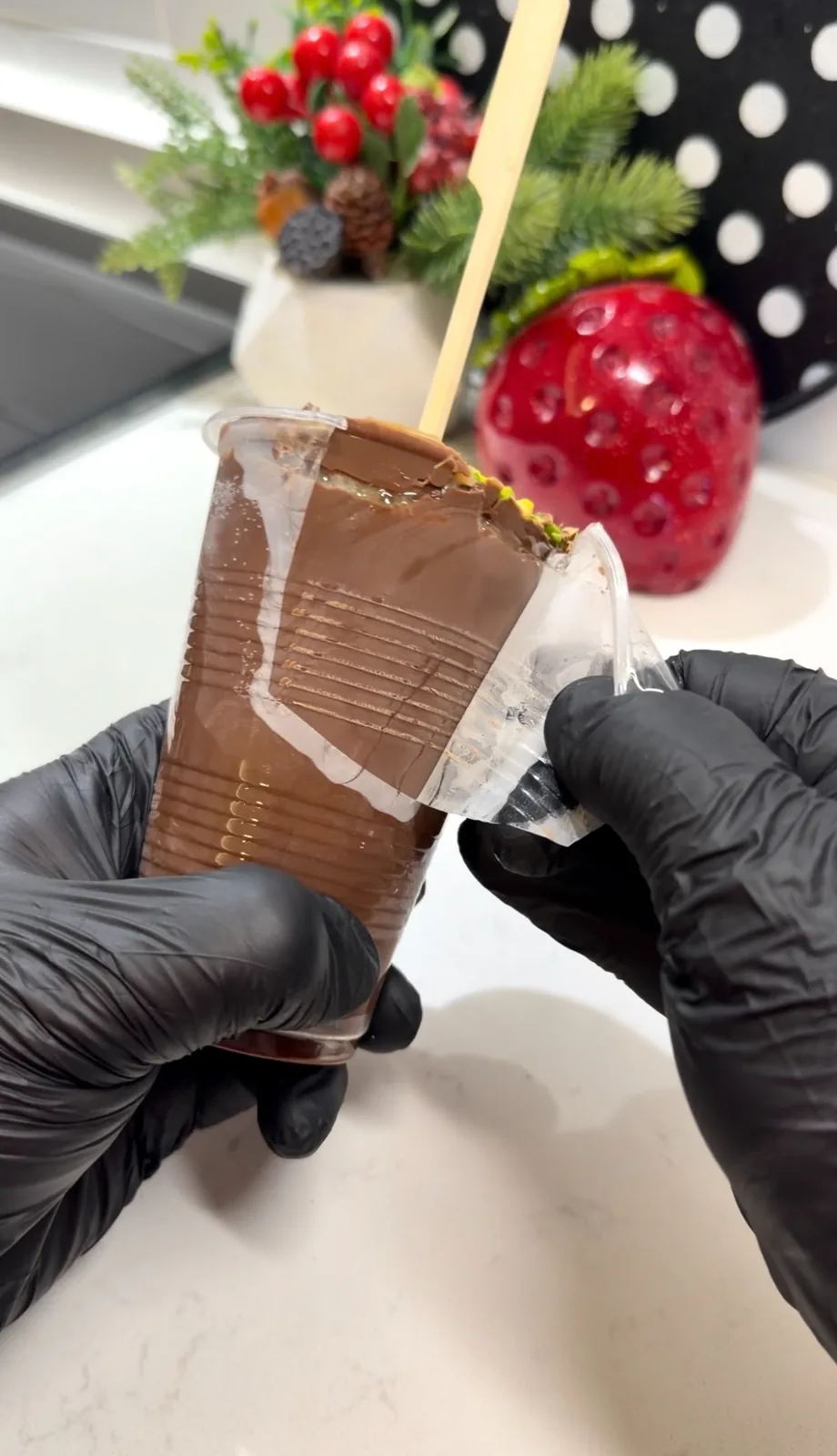 Plastic cup being peeled away from frozen chocolate banana cup ice cream
