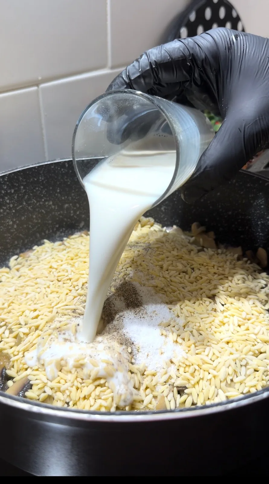 sliced mushrooms and onions sautéing in a pan for creamy mushroom orzo