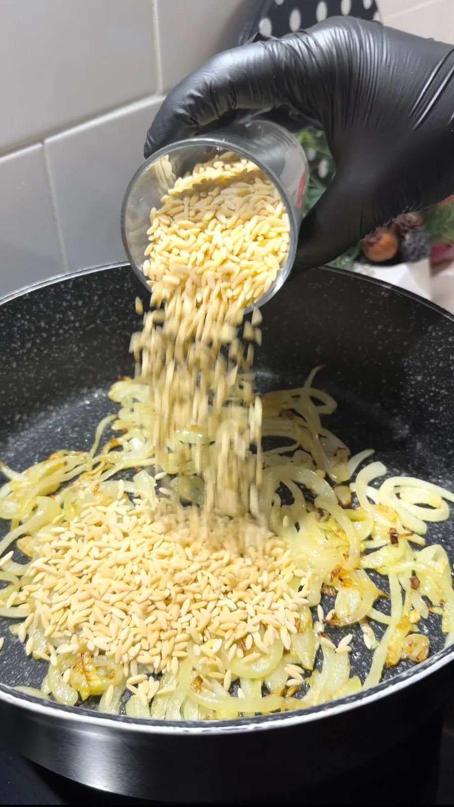 Add the butter and milk once the orzo is nearly cooked. Stir gently and continue cooking briefly until the mixture becomes creamy.