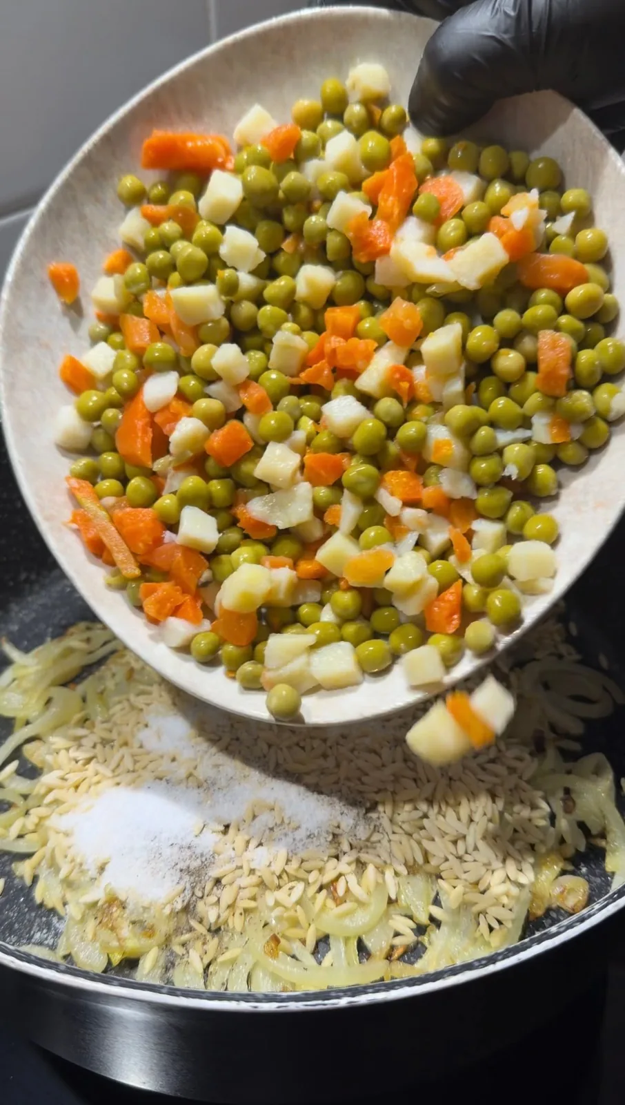 Add the butter and milk once the orzo is nearly cooked. Stir gently and continue cooking briefly until the mixture becomes creamy.