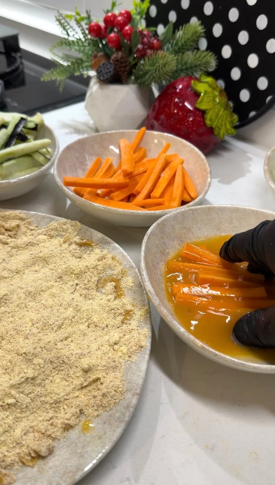 carrot sticks dipped in seasoned egg before breadcrumb coating