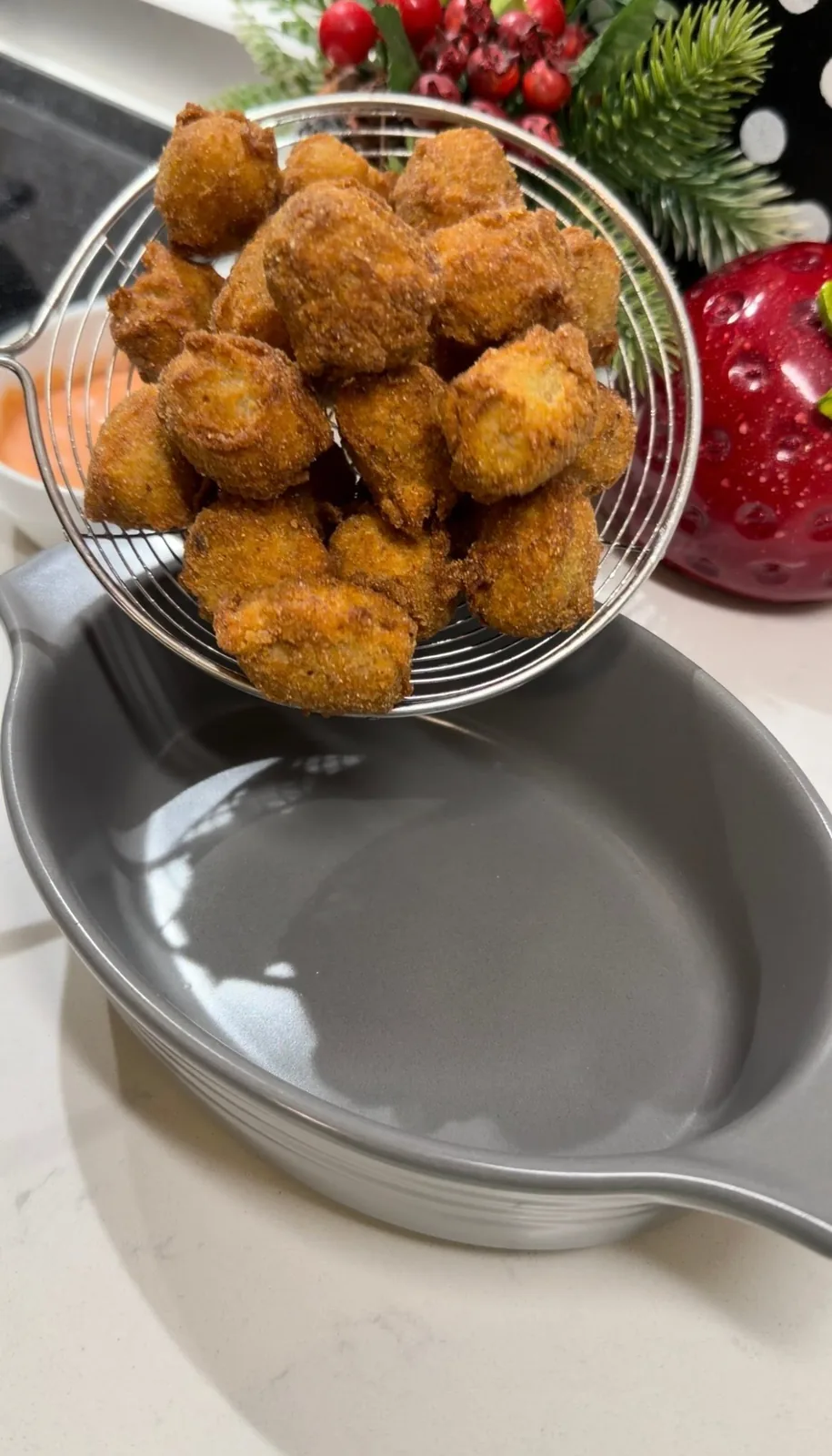 freshly fried crispy olives draining after frying