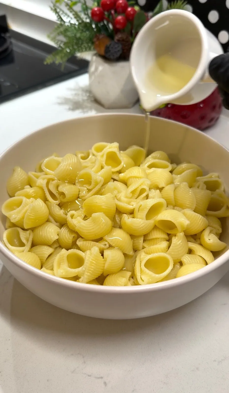 cooked pasta being prepared with oil for crispy pasta chips
