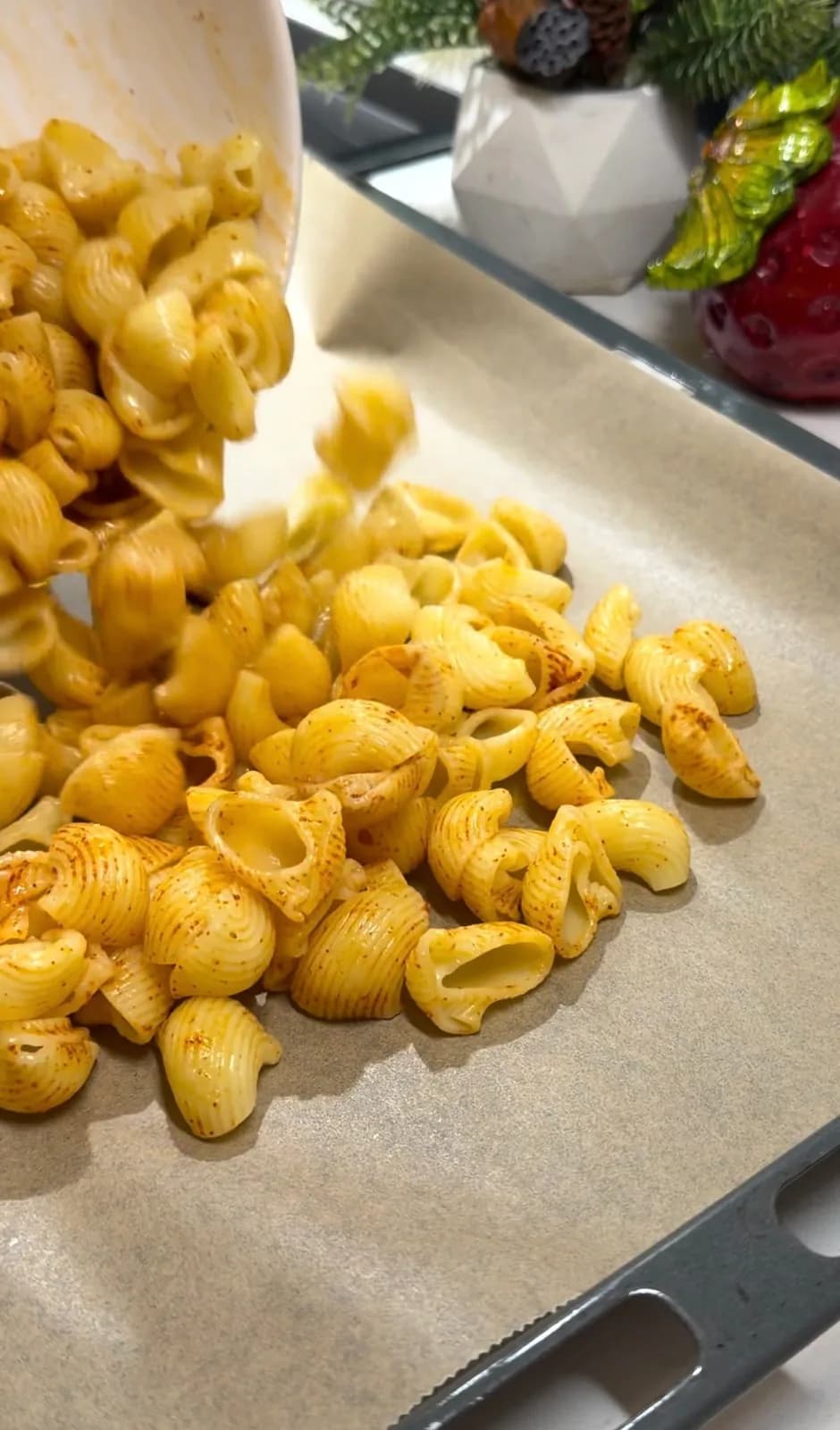 seasoned pasta spread on a baking tray for crispy pasta chips