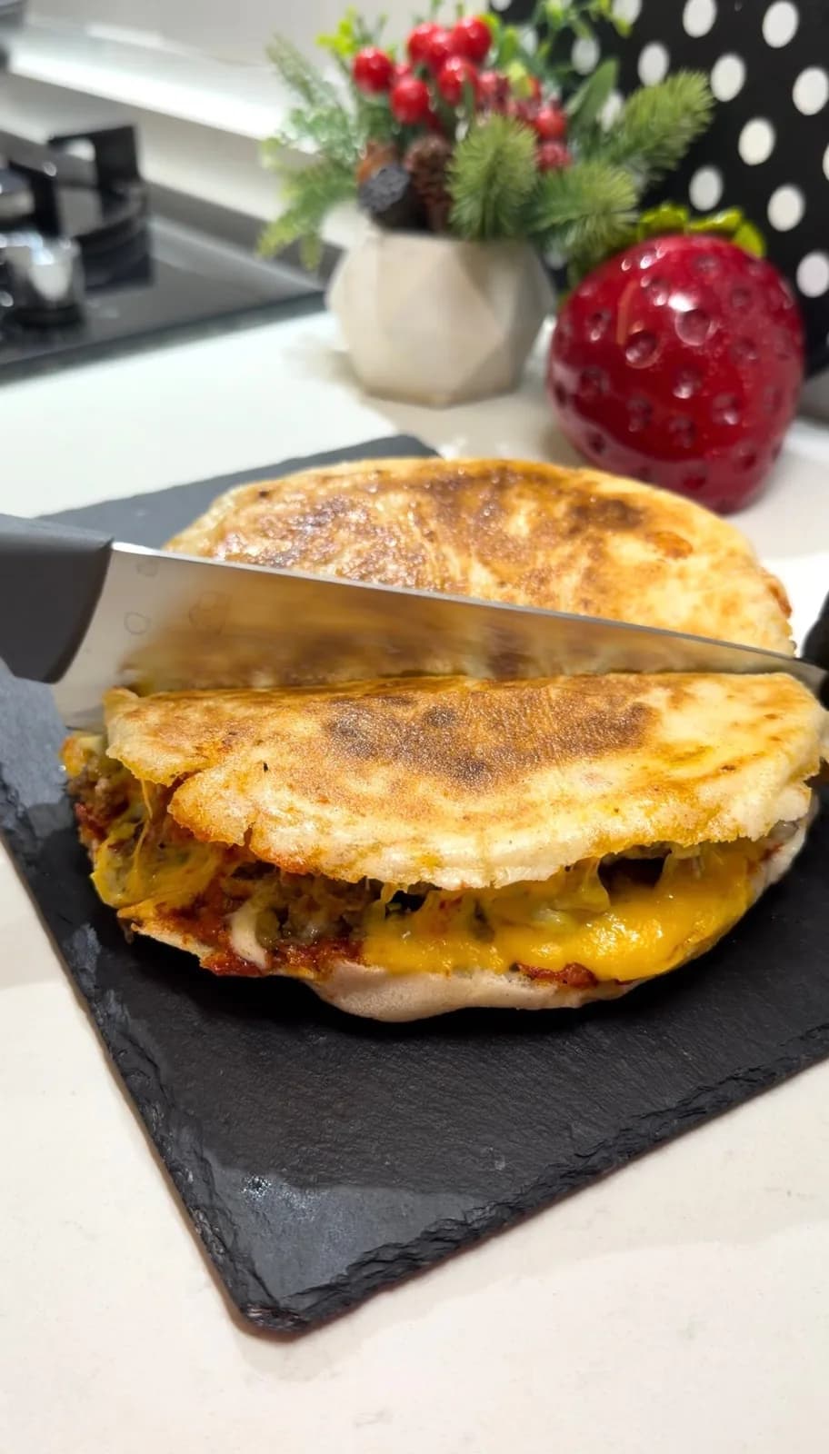 Turkish flatbread burger topped with ground beef and melted cheddar and kasar cheese