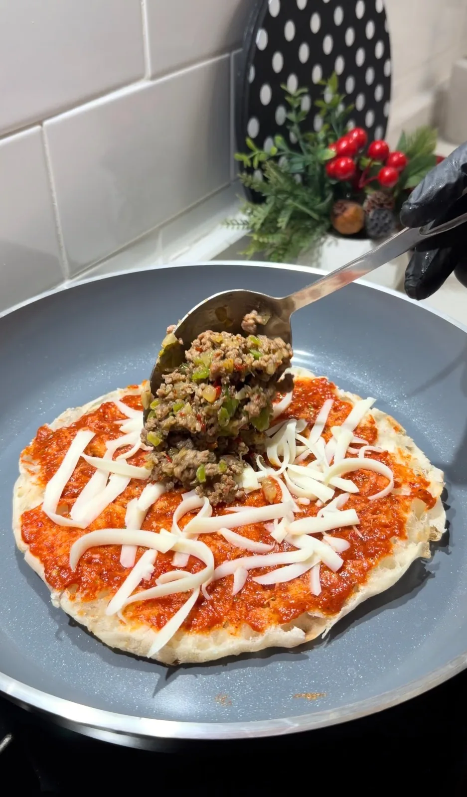 Turkish flatbread burger topped with ground beef and melted cheddar and kasar cheese