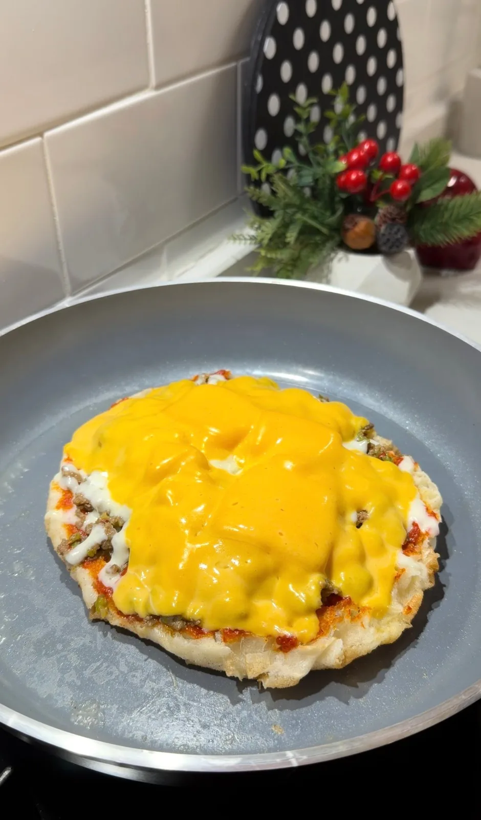Turkish flatbread burger topped with ground beef and melted cheddar and kasar cheese