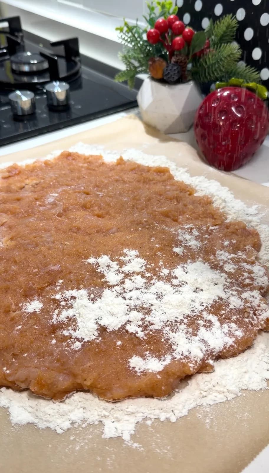 ground chicken breast spread into a large schnitzel on a floured surface
