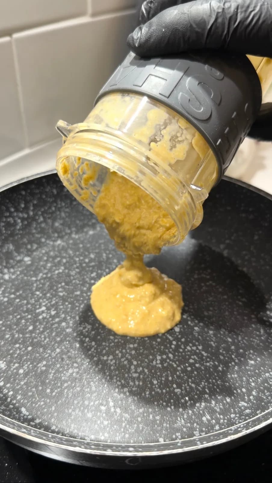 healthy oat pizza batter being poured into a pan