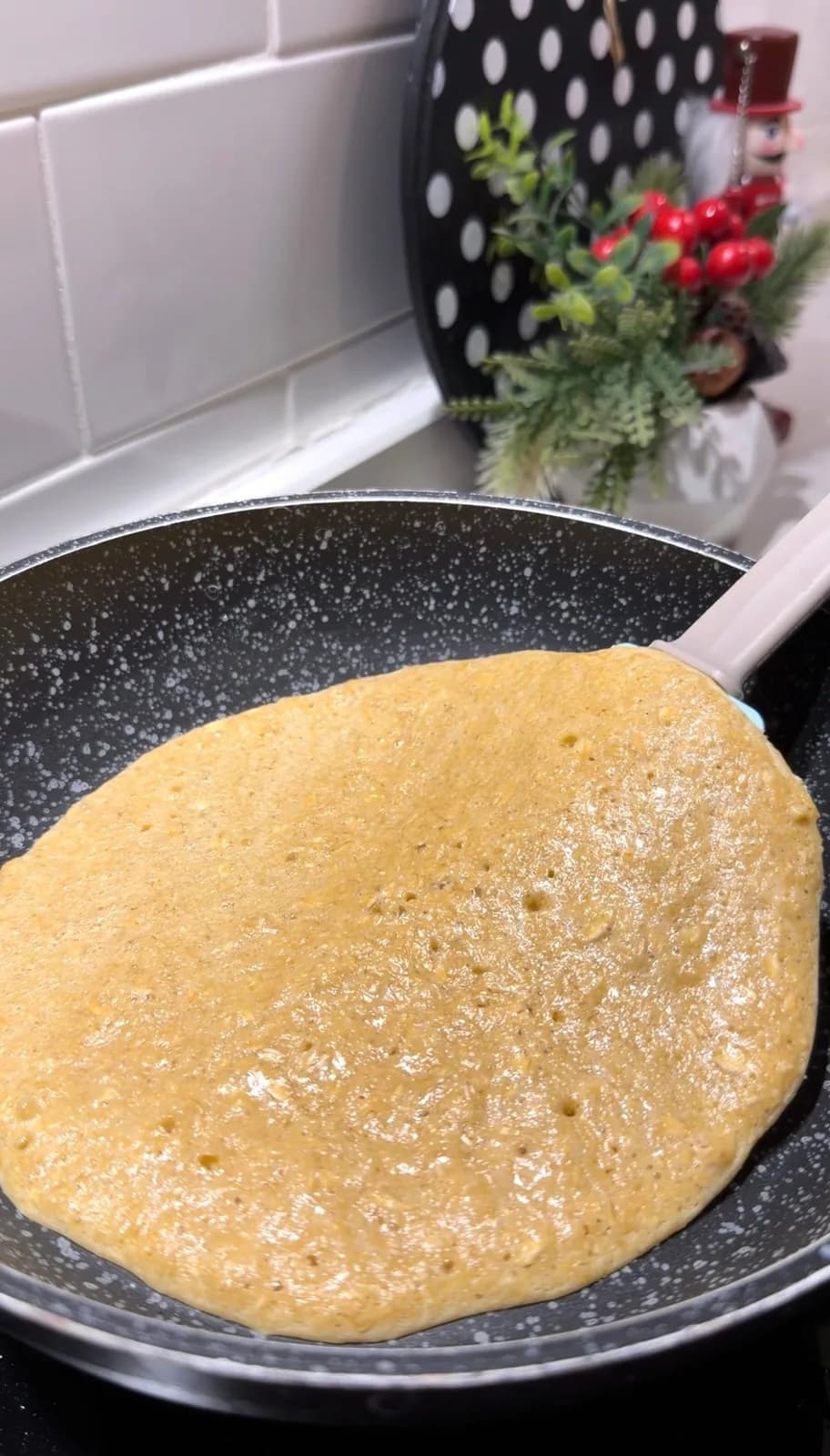 healthy oat pizza base cooking in a nonstick pan