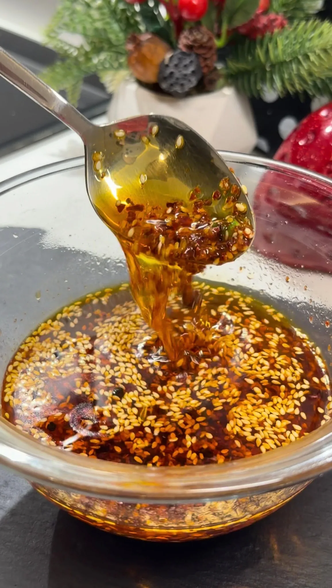 Finished homemade chili oil with sesame seeds and spices in a glass jar
