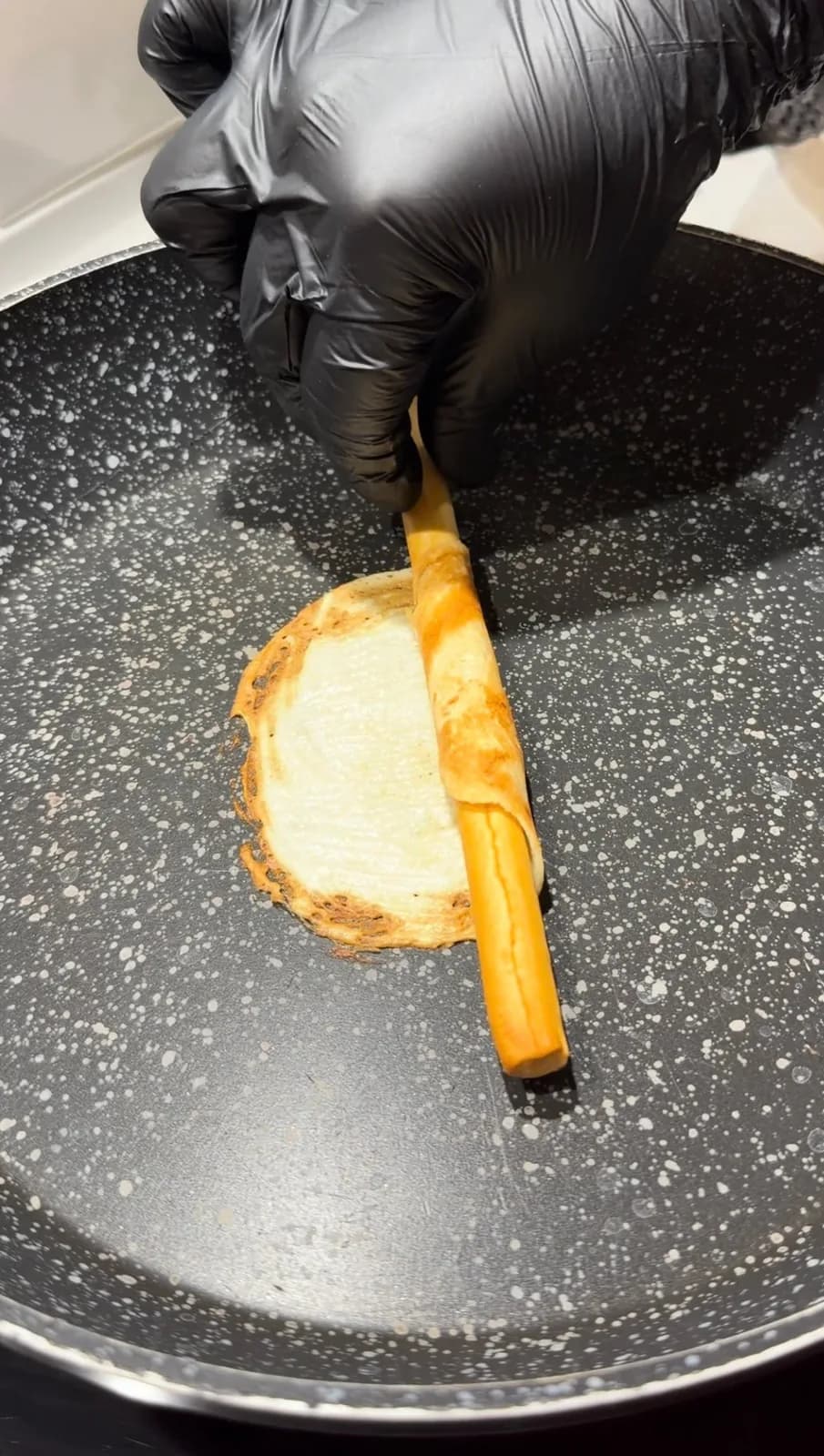 warm wafer cookie rolled around a thin stick to form a crispy tube