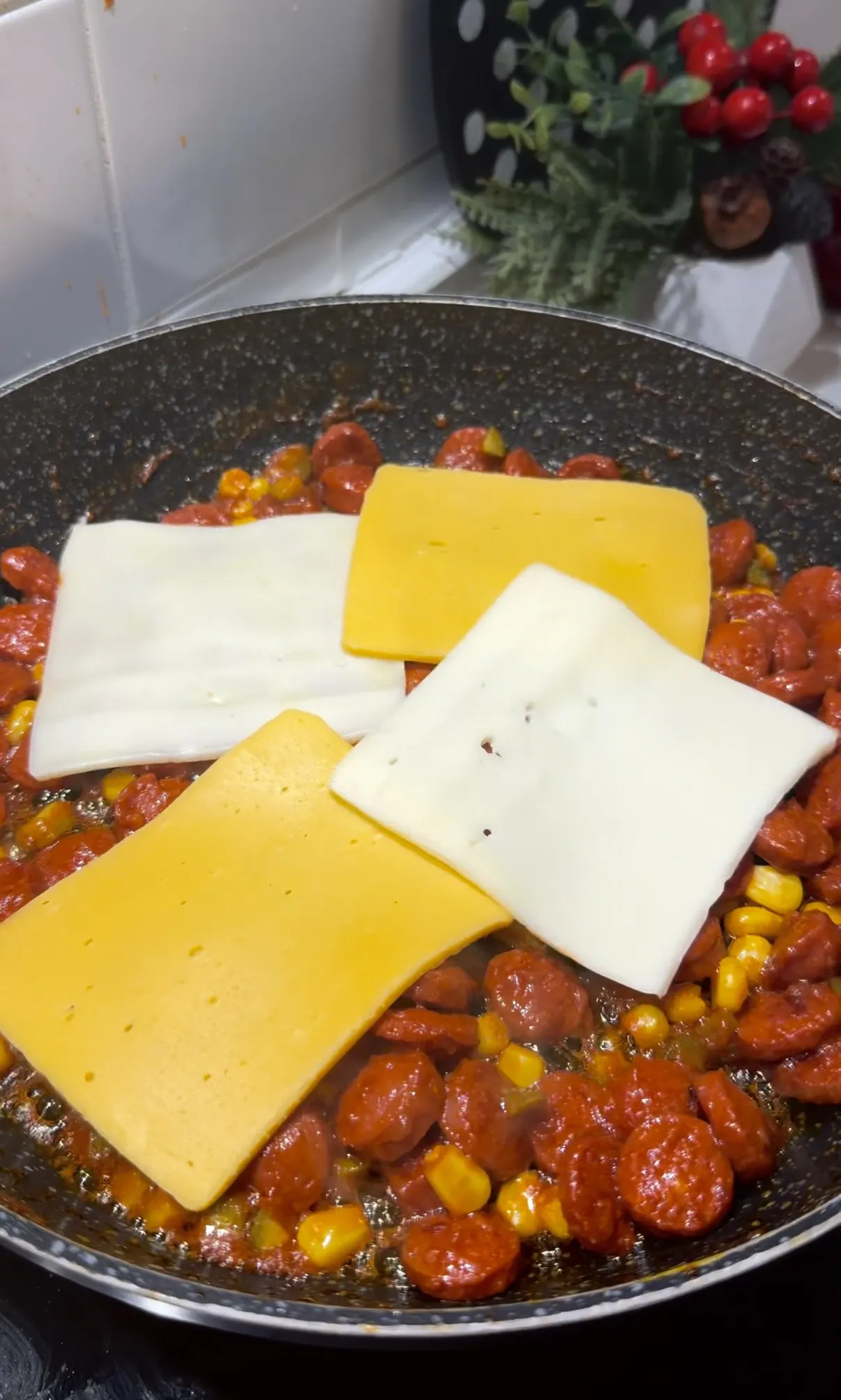 Kaşar and burger cheese slices added over saucy beef sausage