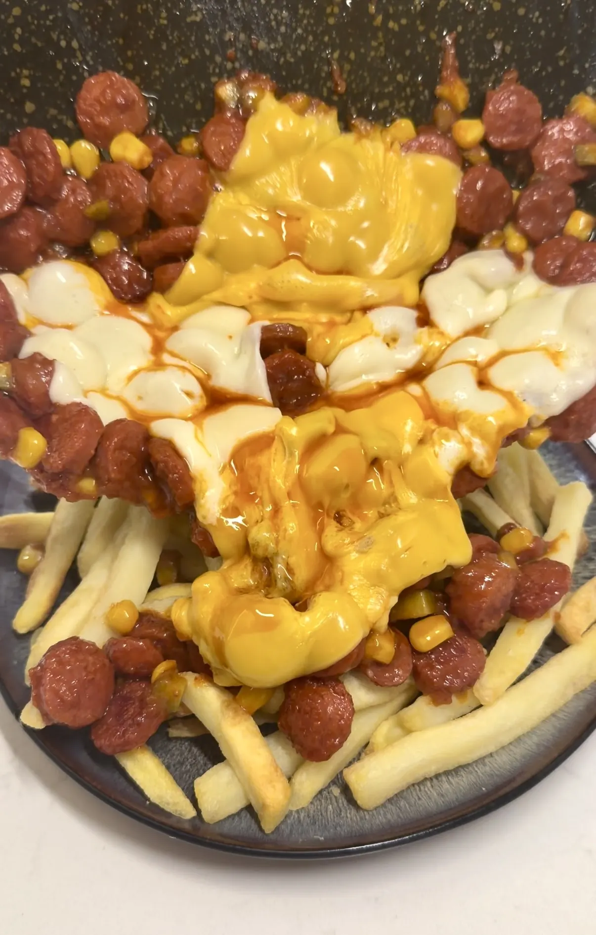 Hot Dog Loaded Fries with beef sausage, corn, pickles, and stretchy melted cheese