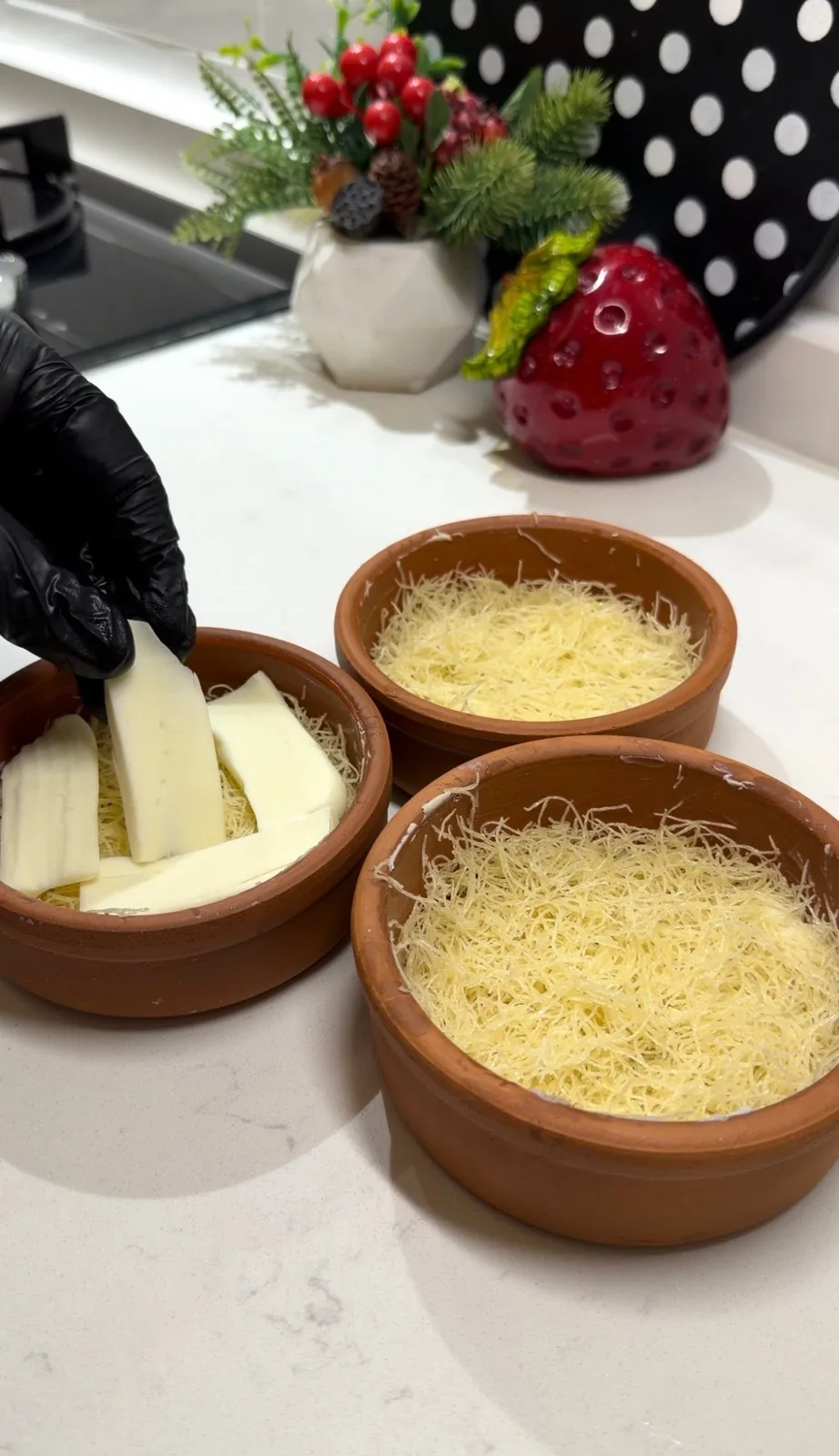 melting cheese layered over shredded kadayif for Turkish kunafa