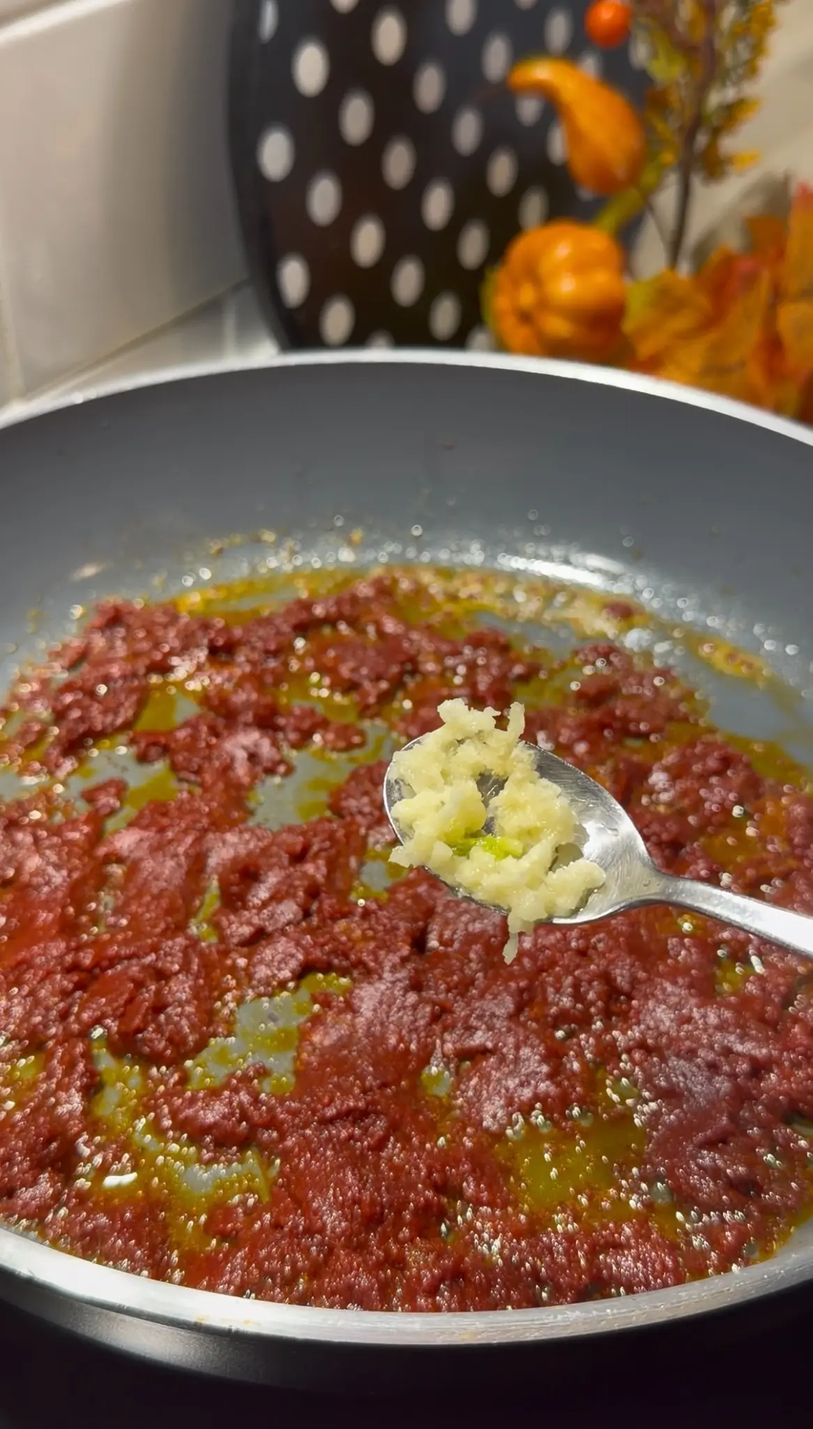 Tomato paste and spices cooking in melted butter for milk and sparkling water chicken