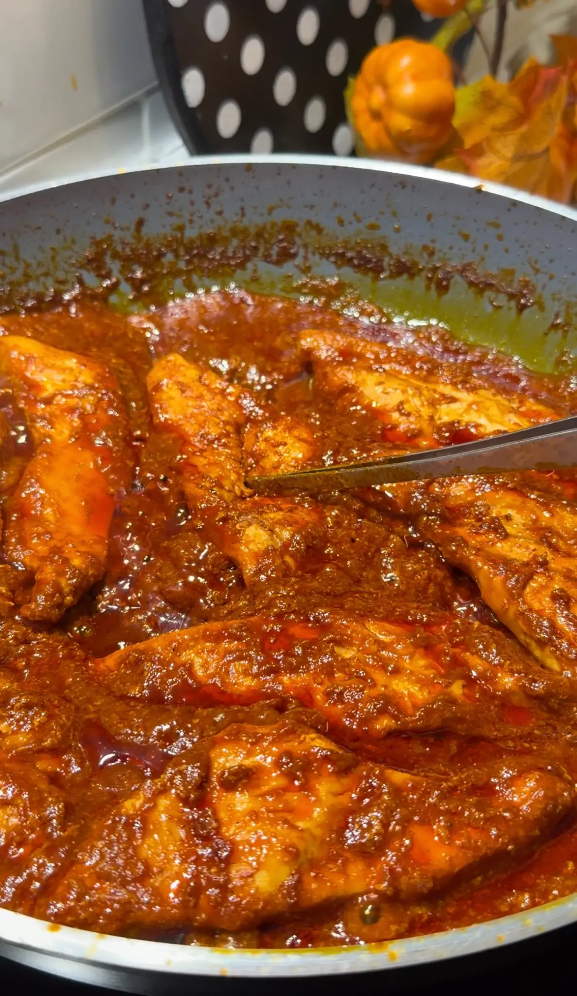 Chicken breast simmering in a thick tomato and spice sauce