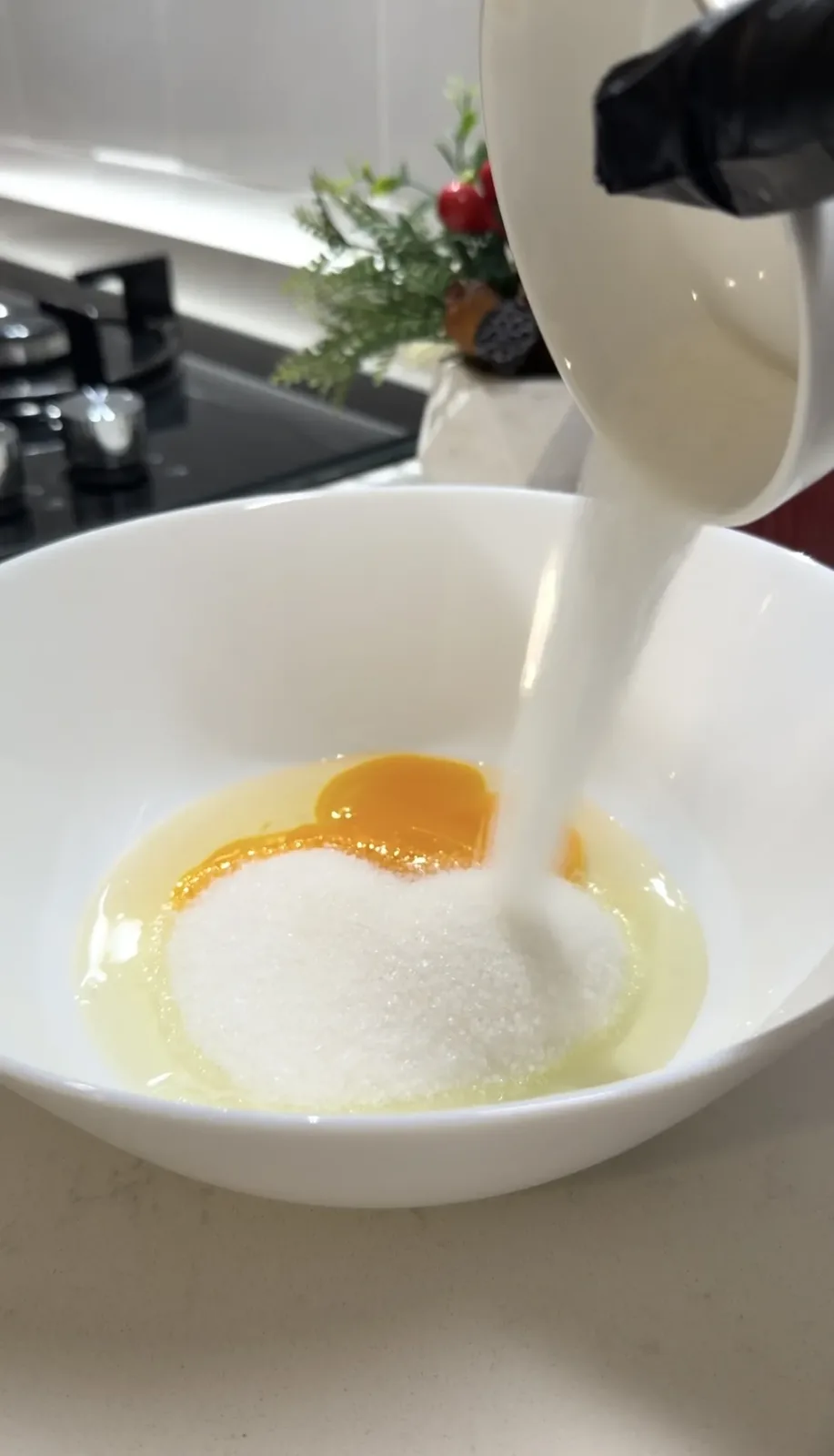 sugar being added to egg mixture for mini Christmas pancakes