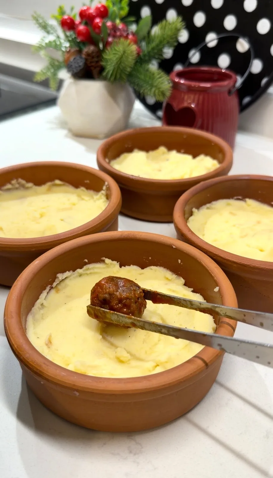 creamy mashed potatoes divided into individual oven-safe casserole dishes