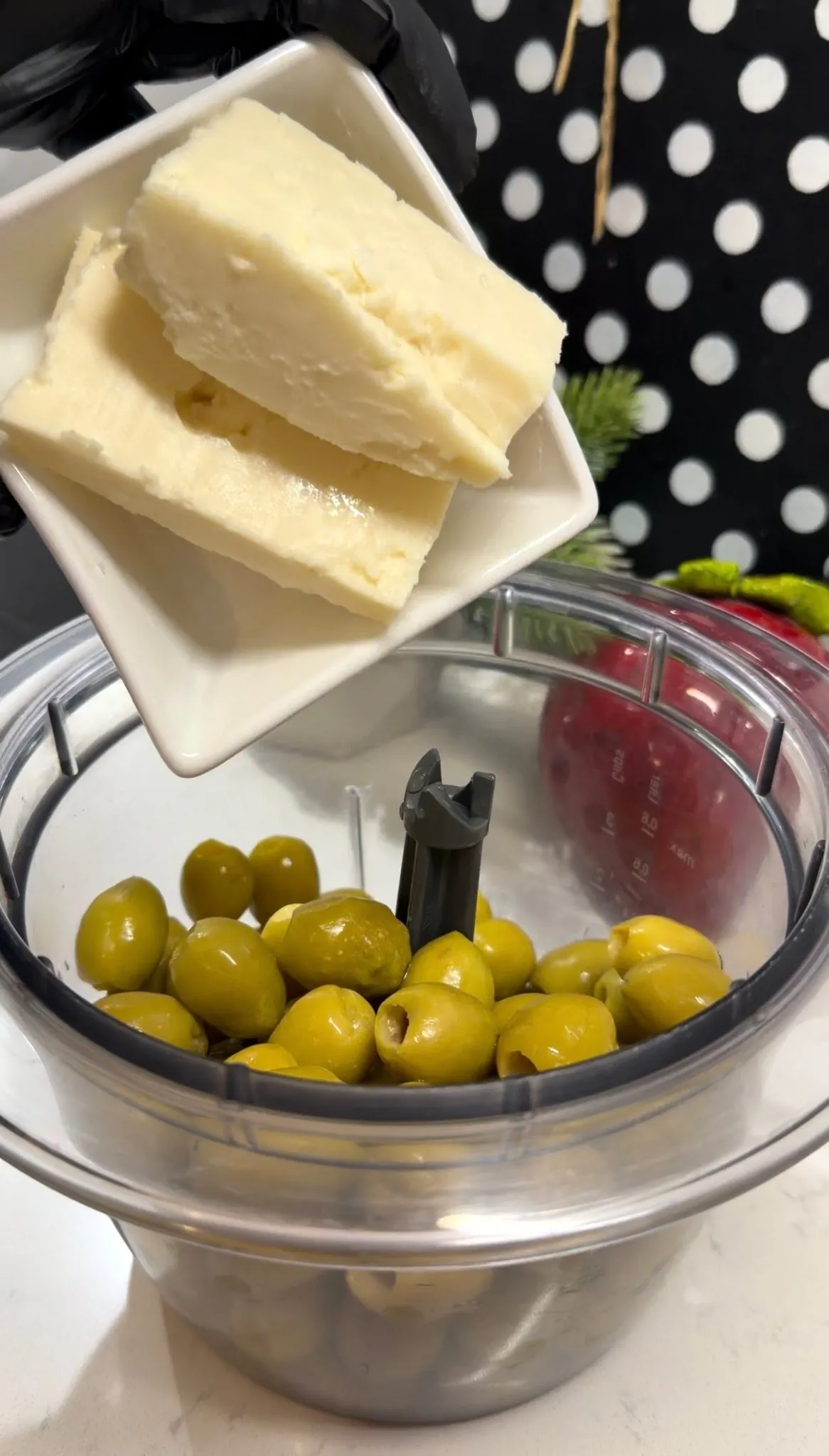 Fresh parsley and seasonings added to olives and feta in a food processor