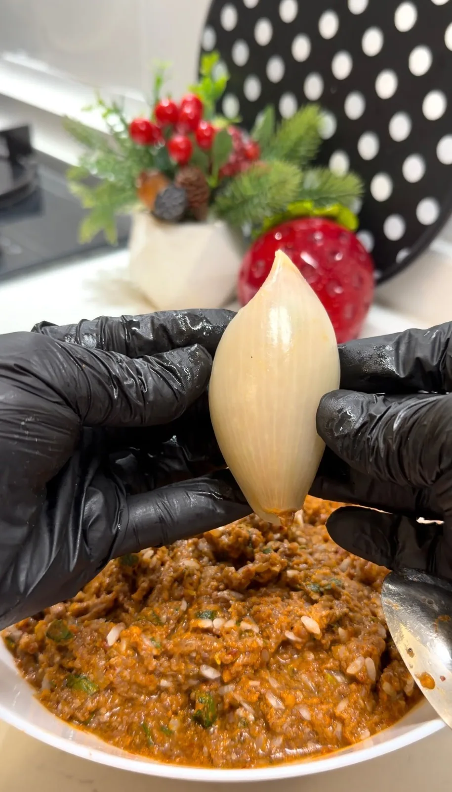 ground beef and rice filling spooned into a softened onion layer for onion dolma