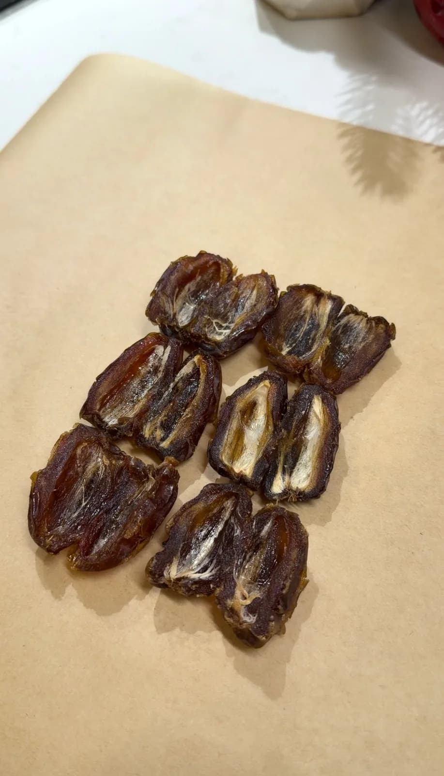 pitted dates arranged on parchment paper for no-bake date dessert