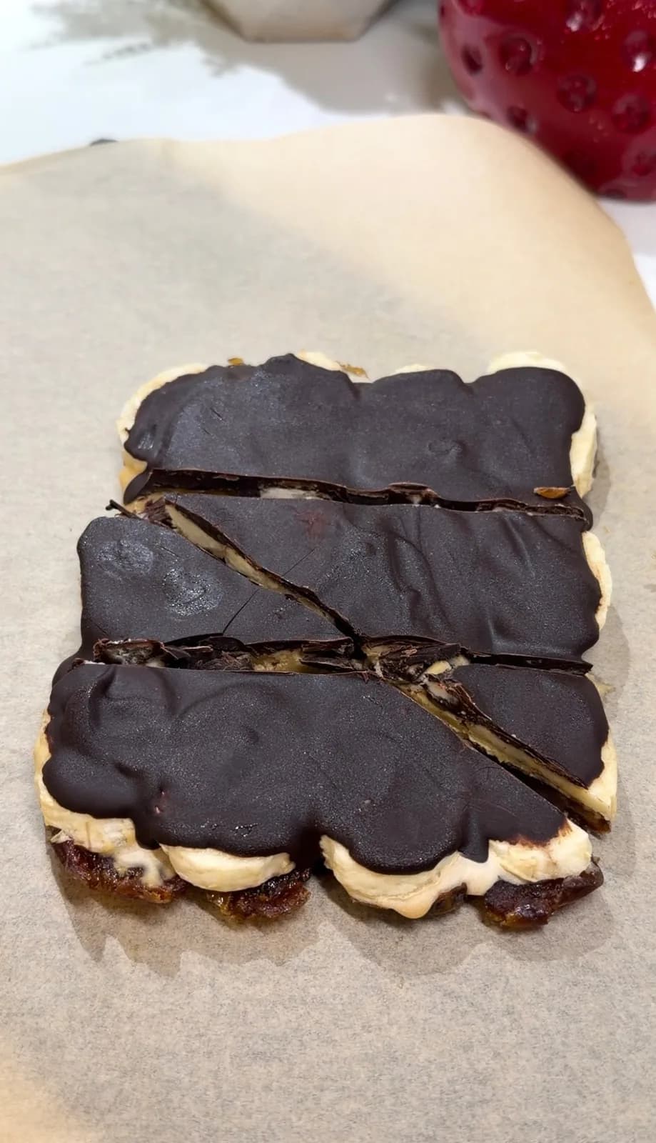no-bake date dessert broken open showing dates peanut butter banana and dark chocolate
