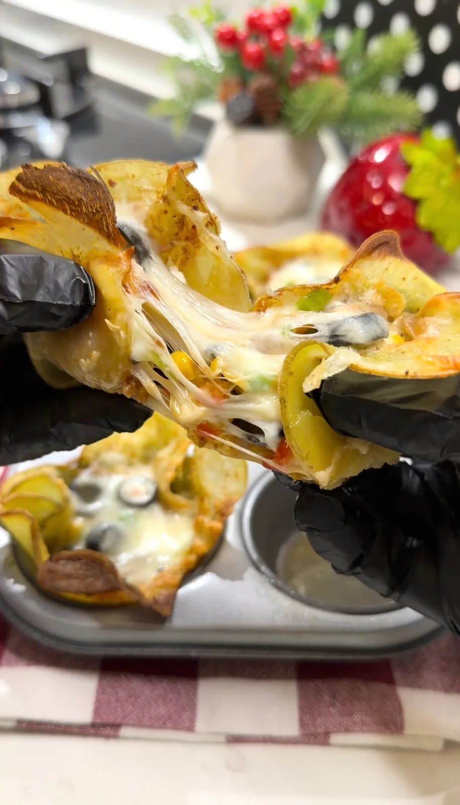 crispy potato flower cup pulled apart with melted cheese stretching from the filling