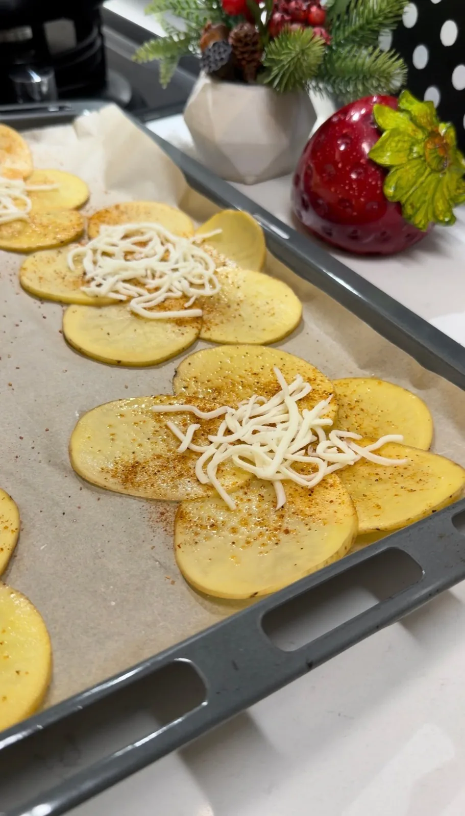thin potato slices arranged into flower shapes with grated cheese before baking