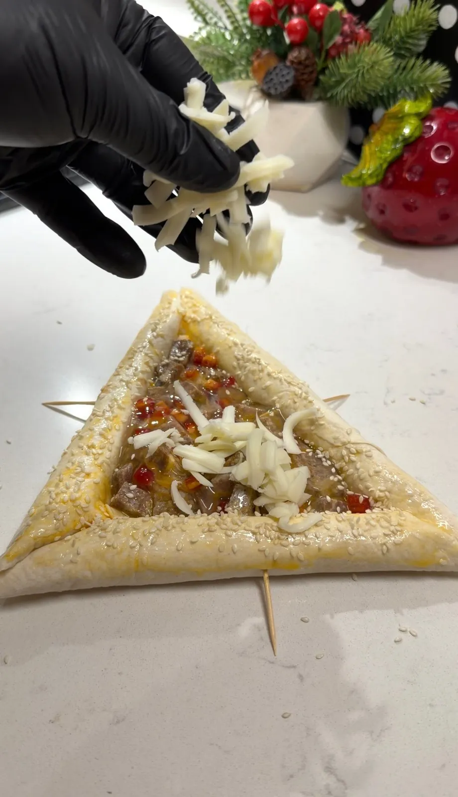 Triangle shaped lavash being filled with egg meat and red pepper