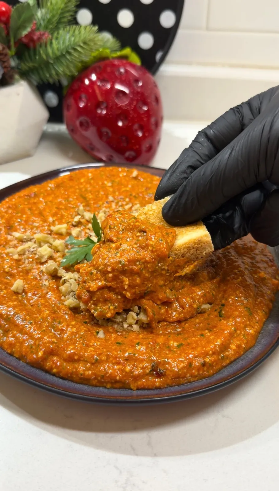 Roasted red pepper feta dip served with chopped walnuts on top