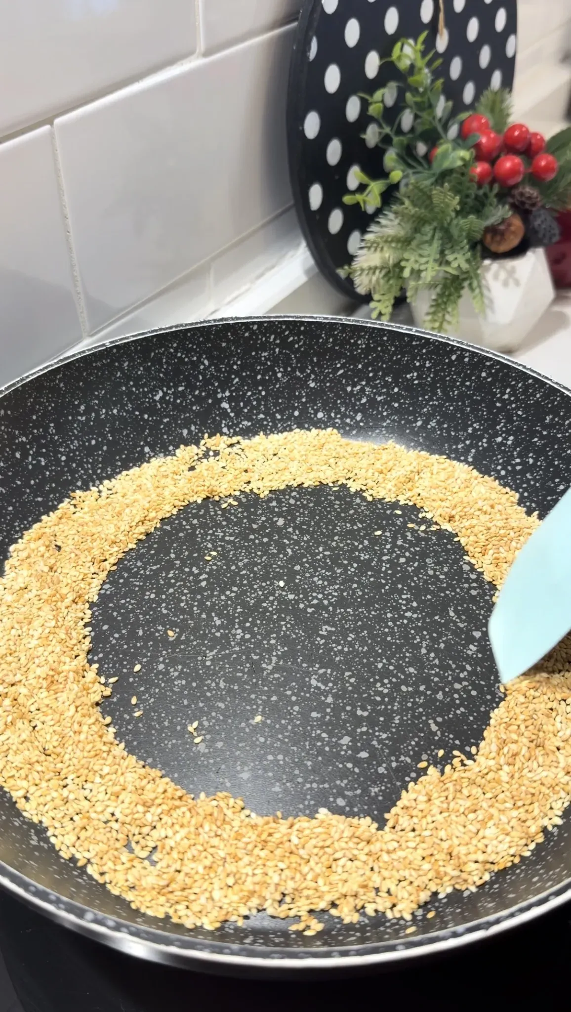 Sesame seeds toasting in a non-stick pan for sesame crusted eggs