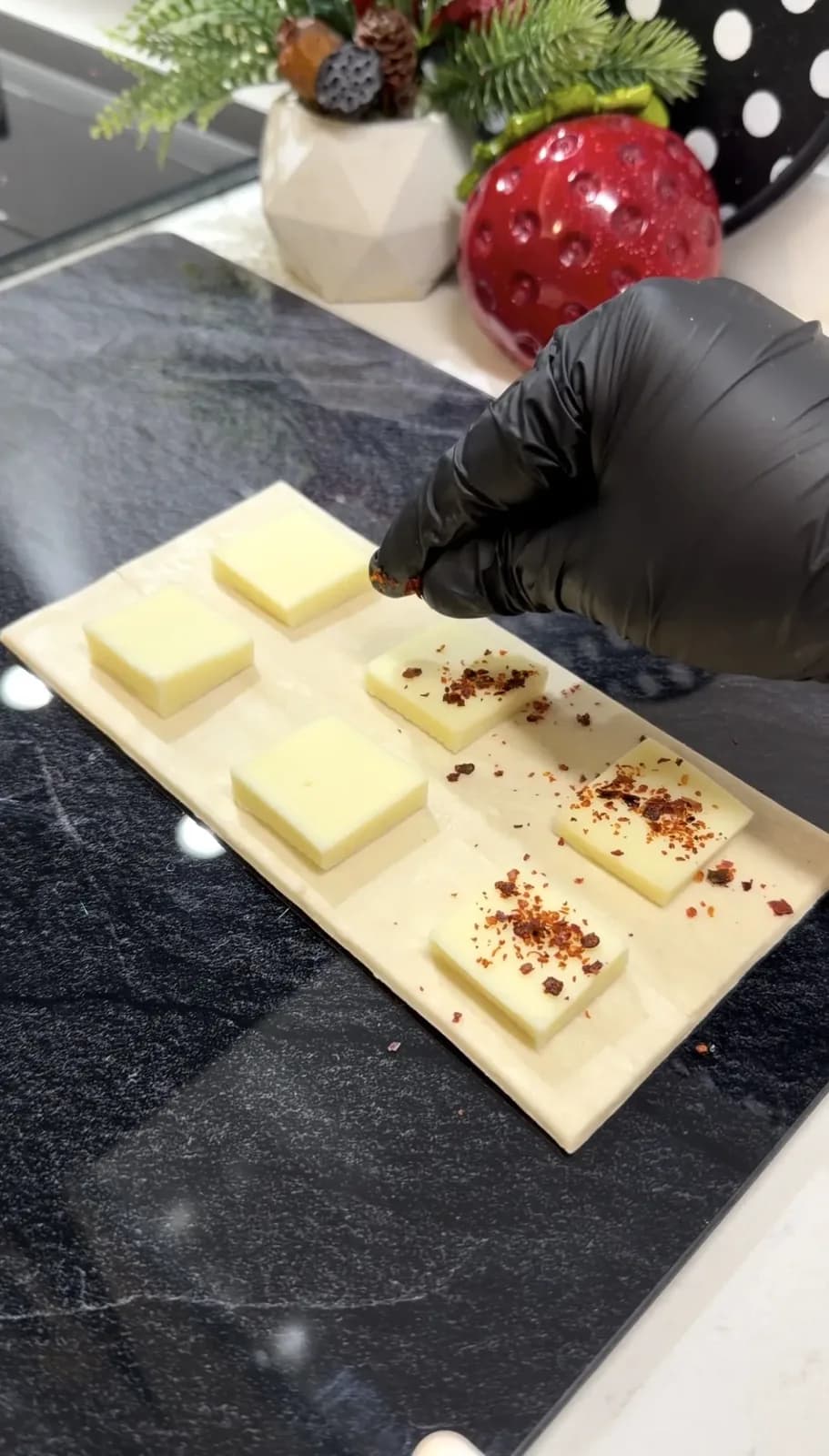 kashar cheese topped with red pepper flakes for sesame puff pastry bites