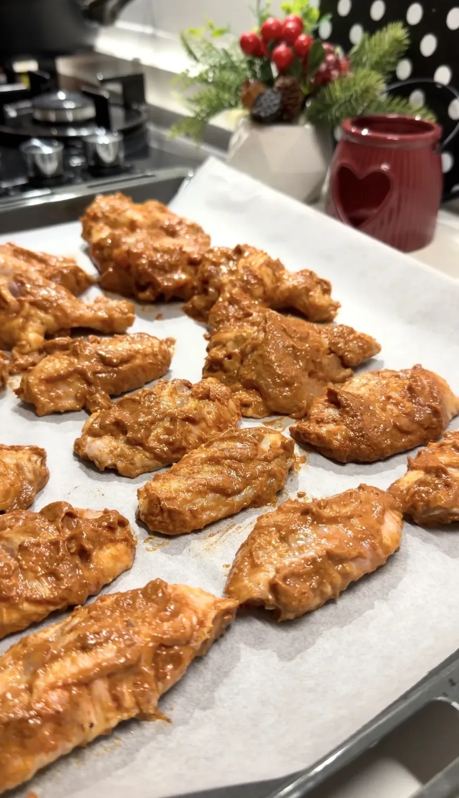 marinated chicken wings arranged on parchment paper before baking