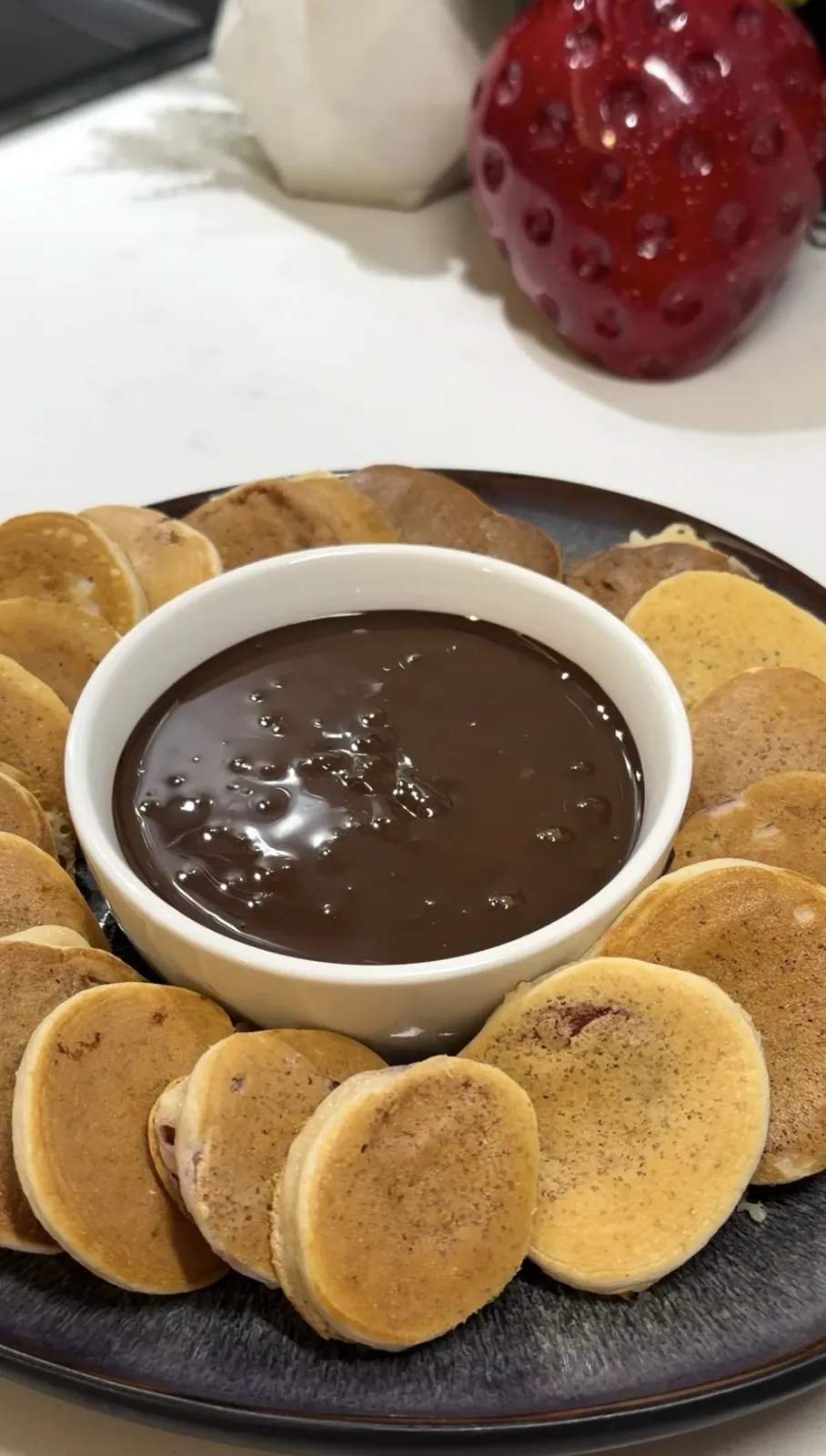 strawberry mini pancakes served with melted chocolate for dipping