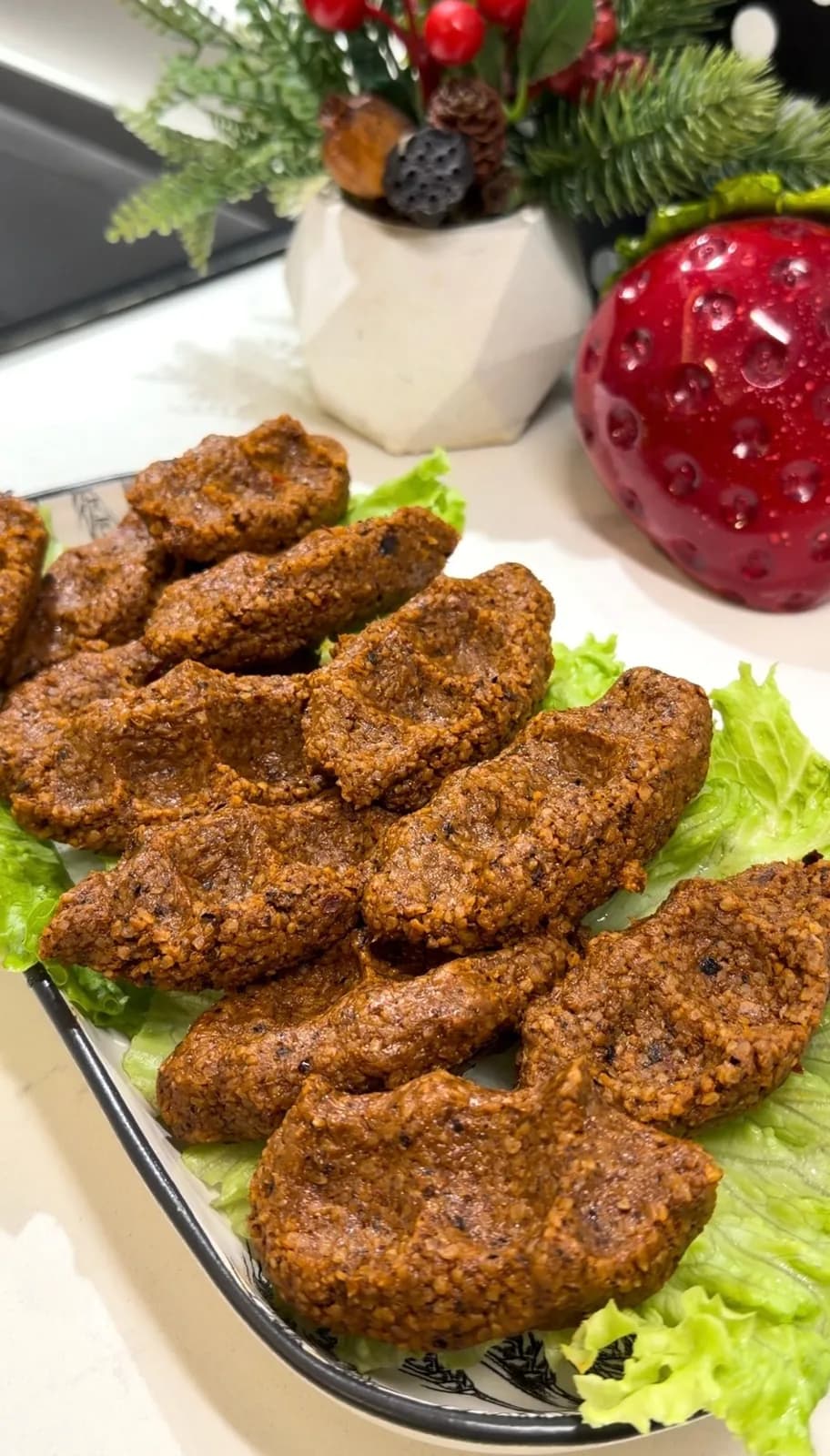 hand-shaped Turkish çiğ köfte with traditional ridged texture