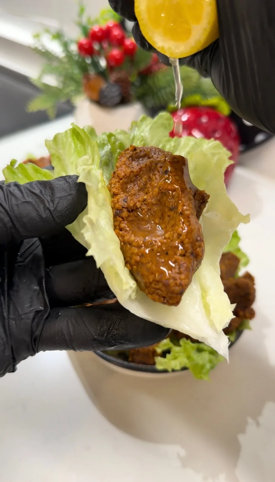 Turkish çiğ köfte wrapped in lettuce and finished with fresh lemon juice